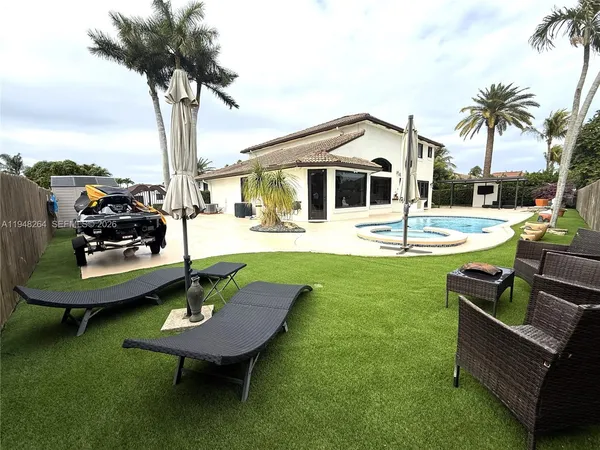 a view of a backyard with a table and chairs