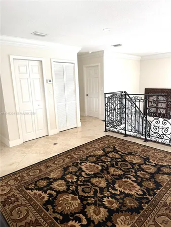 a view of a livingroom with wooden floor and a cabinet