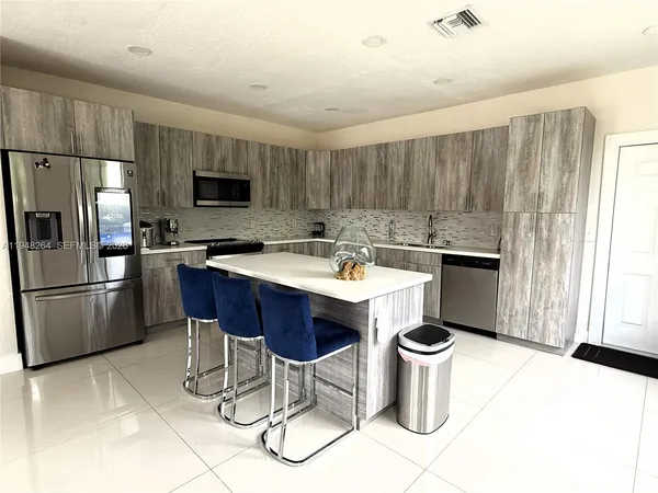 a kitchen with a sink cabinets and stainless steel appliances
