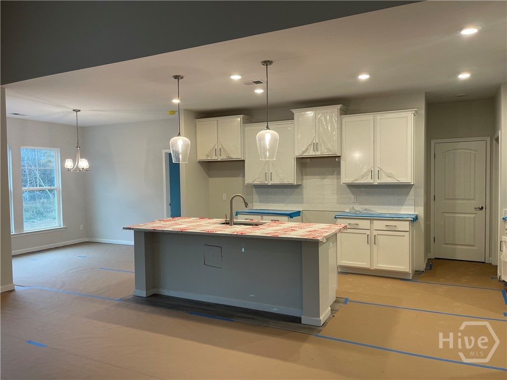 150 Como Drive Pooler, GA 31322 - Photo 3 of 7 Gorgeous White Kitchen with Large Island and Quartz Counter Tops