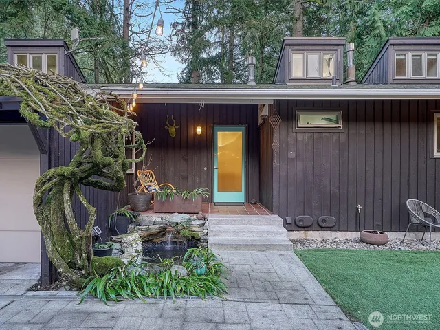 a view of a house with backyard and sitting area