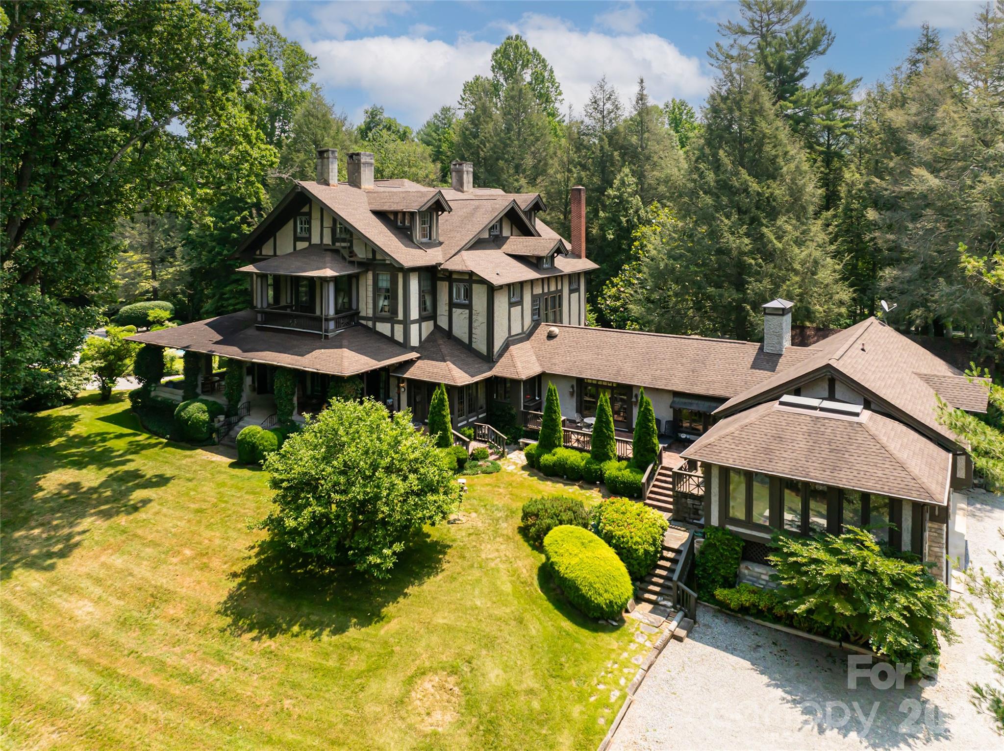 2531 Little River Road Hendersonville, NC 28739 - Photo 36 of 48 a view of a house with swimming pool lawn chairs and a yard