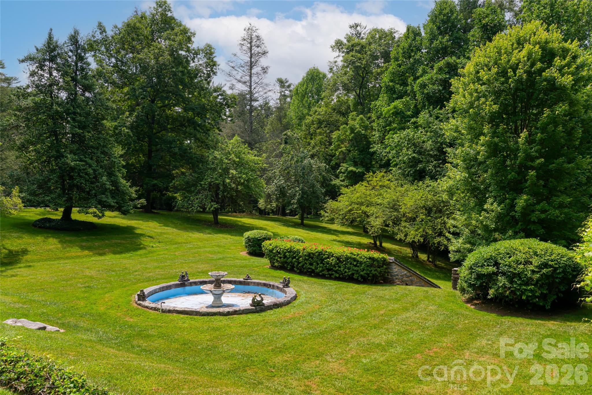 2531 Little River Road Hendersonville, NC 28739 - Photo 39 of 48 a view of a swimming pool with a bench and trees in the background