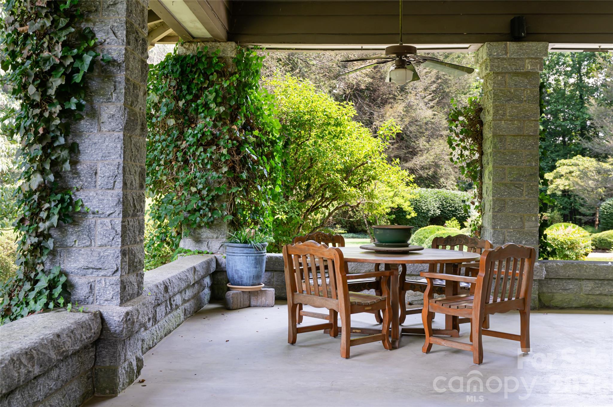 2531 Little River Road Hendersonville, NC 28739 - Photo 4 of 48 a patio with table and chairs and potted plants