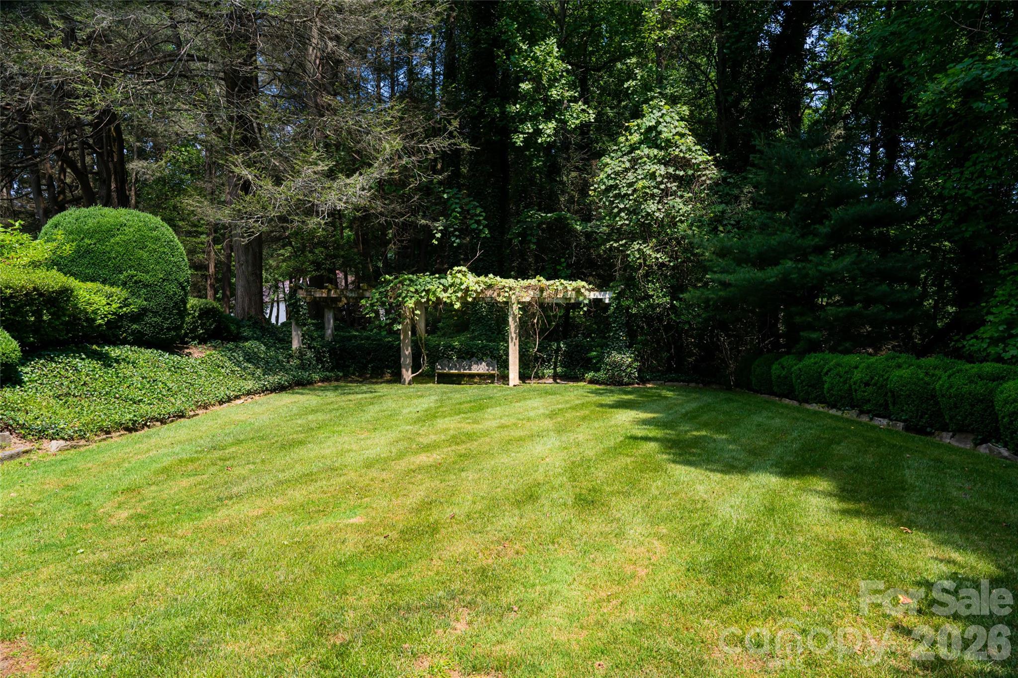 2531 Little River Road Hendersonville, NC 28739 - Photo 42 of 48 a view of a backyard with a garden and entertaining space