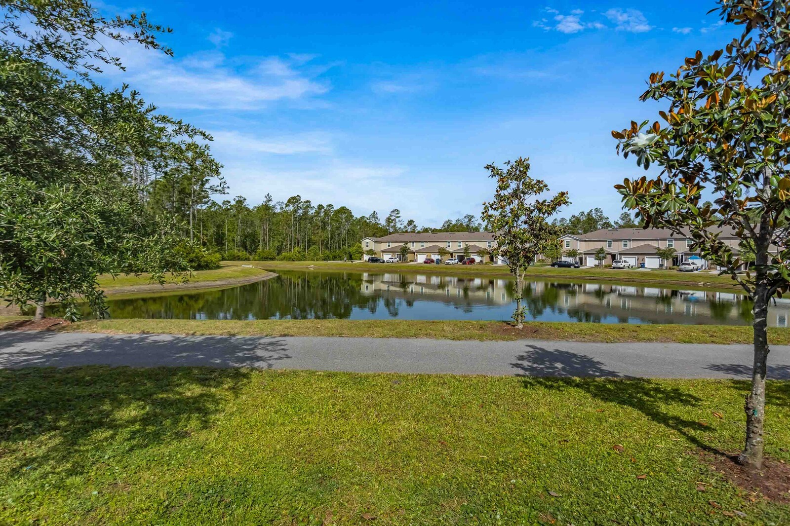 86784 Mainline Road Yulee, FL 32097 - Photo 24 of 25 a view of a lake with houses in the back