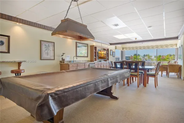a living room with stainless steel appliances granite countertop furniture and a kitchen view