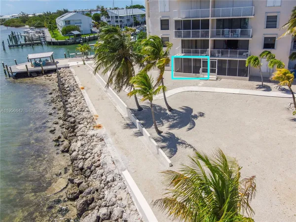 a view of a swimming pool with a yard and sitting space