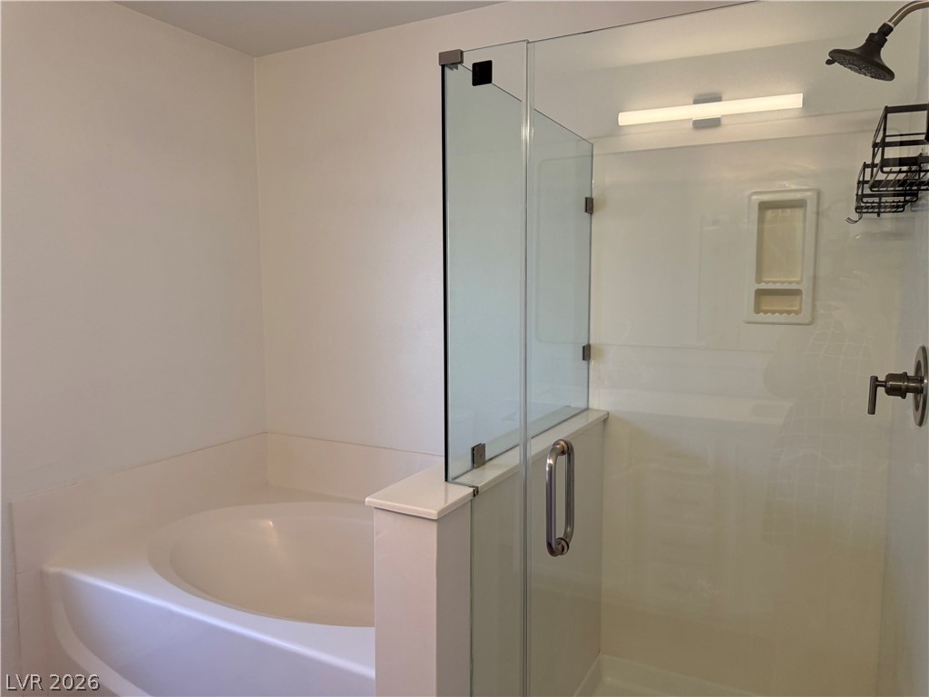 1141 Cathedral Ridge Street Henderson, NV 89052 - Photo 56 of 77 Relax in the soaking tub or refresh in the shower, offering a blend of comfort and utility.