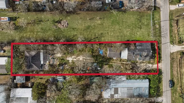 an aerial view of residential houses and car parked