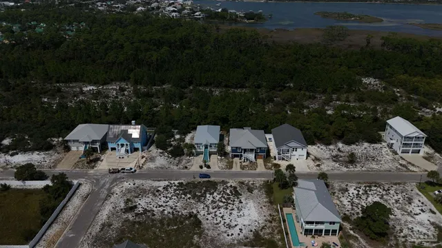 an aerial view of a house with a yard fire pit and outdoor seating