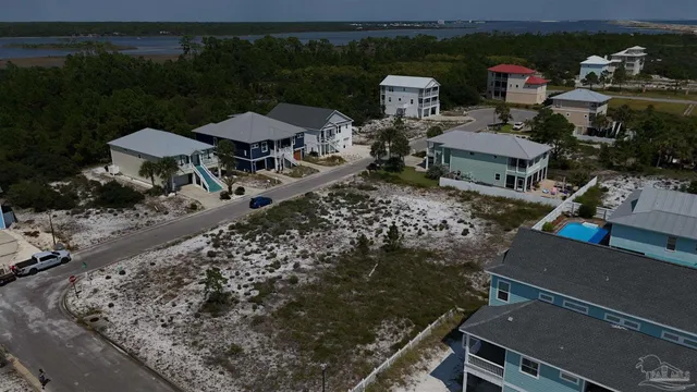 an aerial view of a house with a yard basket ball court and outdoor seating