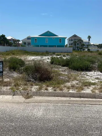 a front view of a house with a yard and lake view