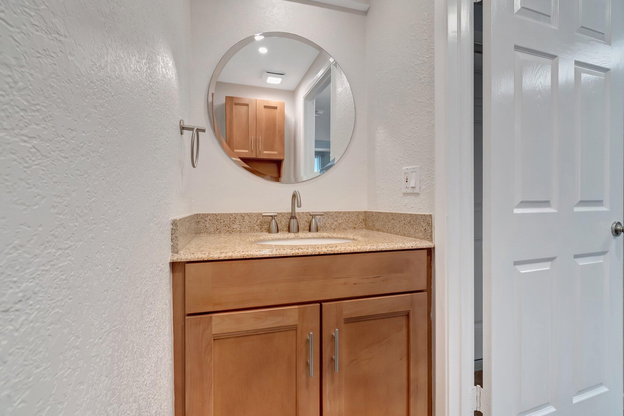 1016 Jeffery Street, Unit 1016 Boca Raton, FL 33487 - Photo 22 of 65 a bathroom with a sink and a mirror