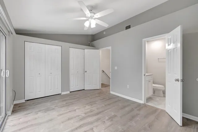 wooden floor in an empty room with a bathroom
