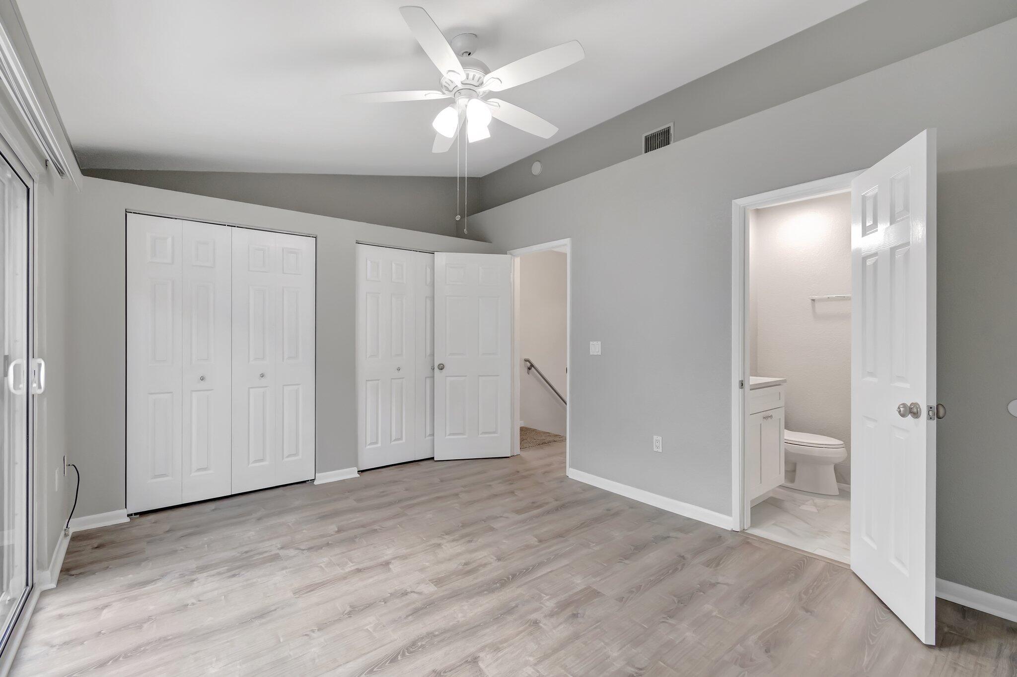 1016 Jeffery Street, Unit 1016 Boca Raton, FL 33487 - Photo 3 of 65 wooden floor in an empty room with a bathroom