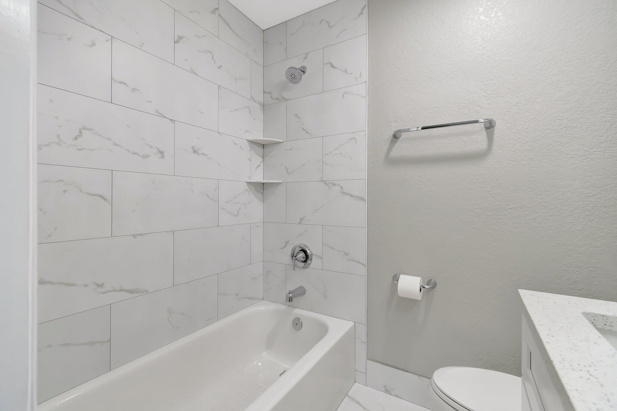 1016 Jeffery Street, Unit 1016 Boca Raton, FL 33487 - Photo 38 of 65 a bathroom with a toilet and bathtub