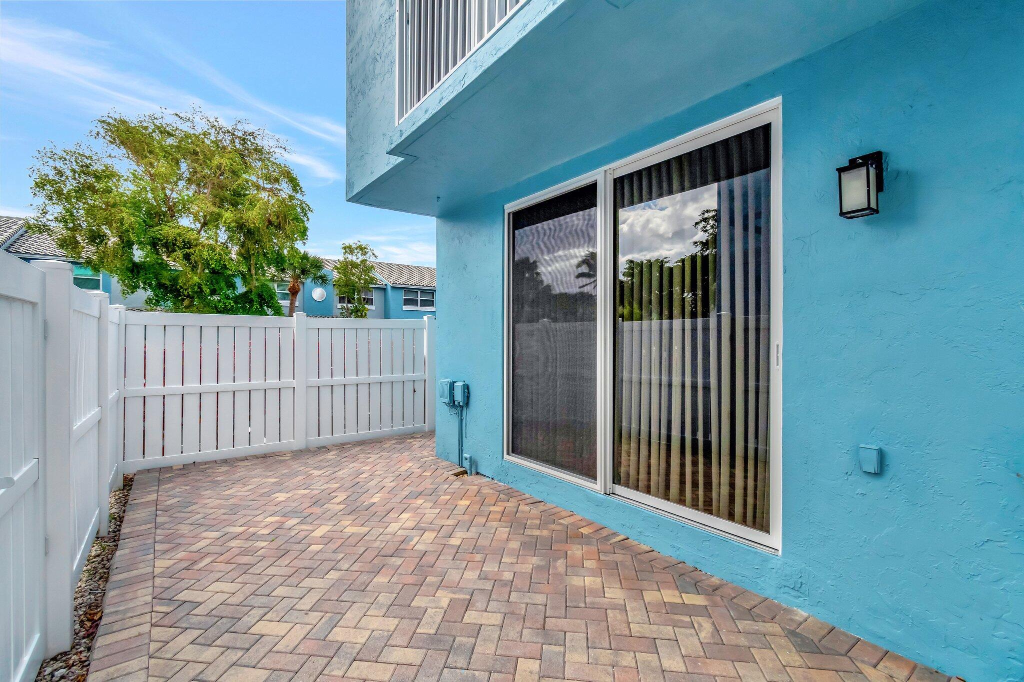 1016 Jeffery Street, Unit 1016 Boca Raton, FL 33487 - Photo 41 of 65 a view of a porch with a small yard