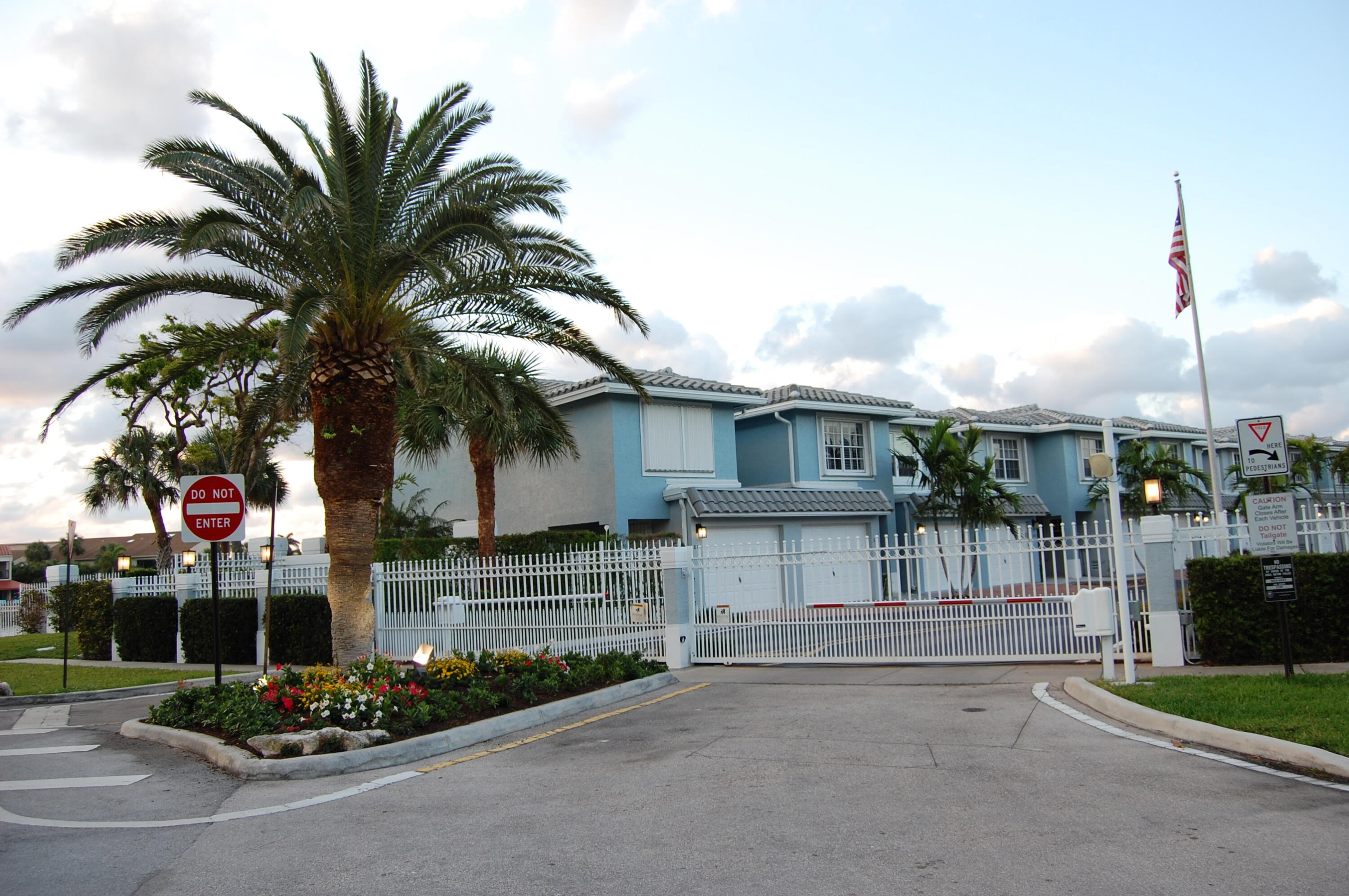 1016 Jeffery Street, Unit 1016 Boca Raton, FL 33487 - Photo 58 of 65 a view of a house with a small yard and palm trees