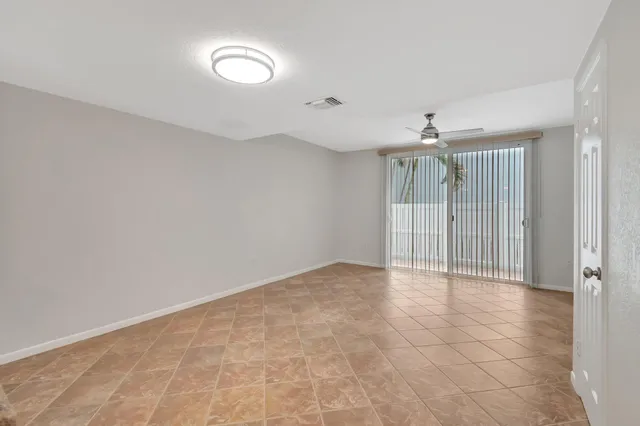 a view of an empty room with a fan