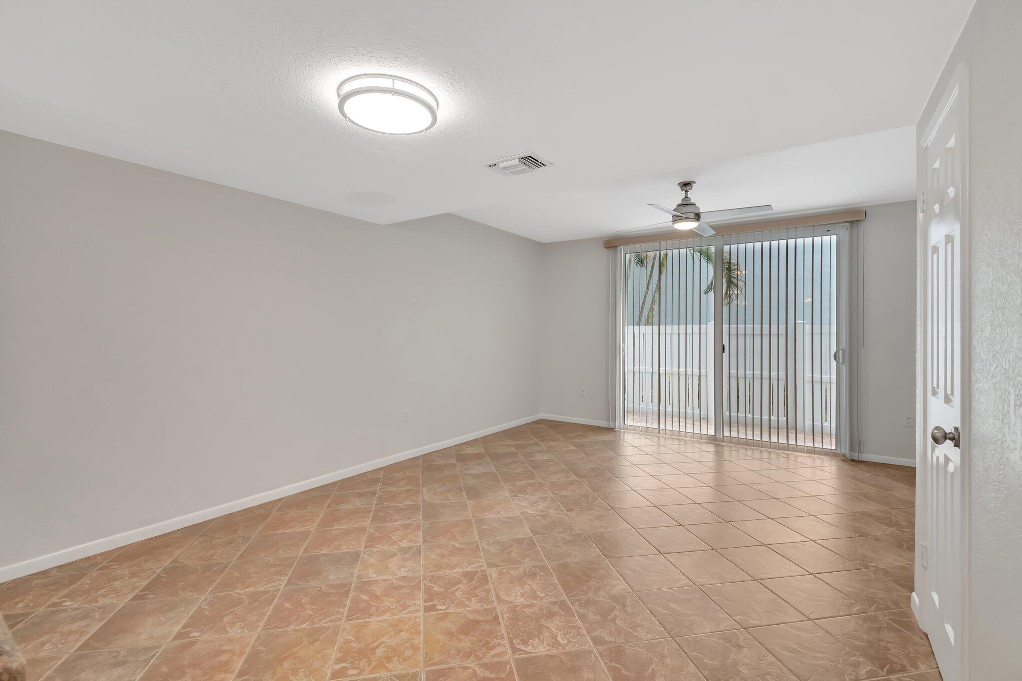 1016 Jeffery Street, Unit 1016 Boca Raton, FL 33487 - Photo 7 of 65 a view of an empty room with a fan
