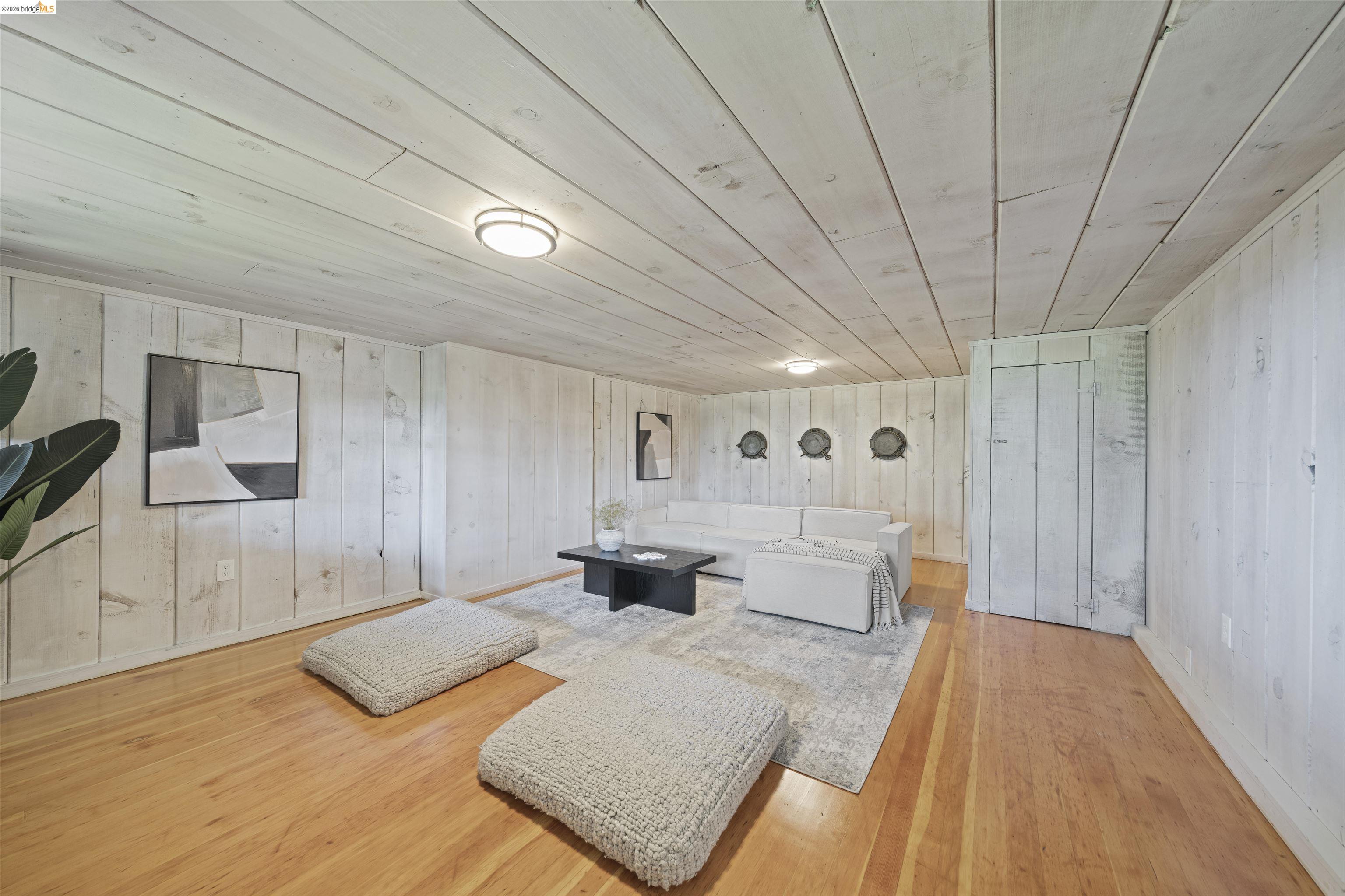 1170 Sterling Avenue Berkeley, CA 94708 - Photo 42 of 52 Living area featuring hardwood / wood-style floors, wooden walls, and wood ceiling