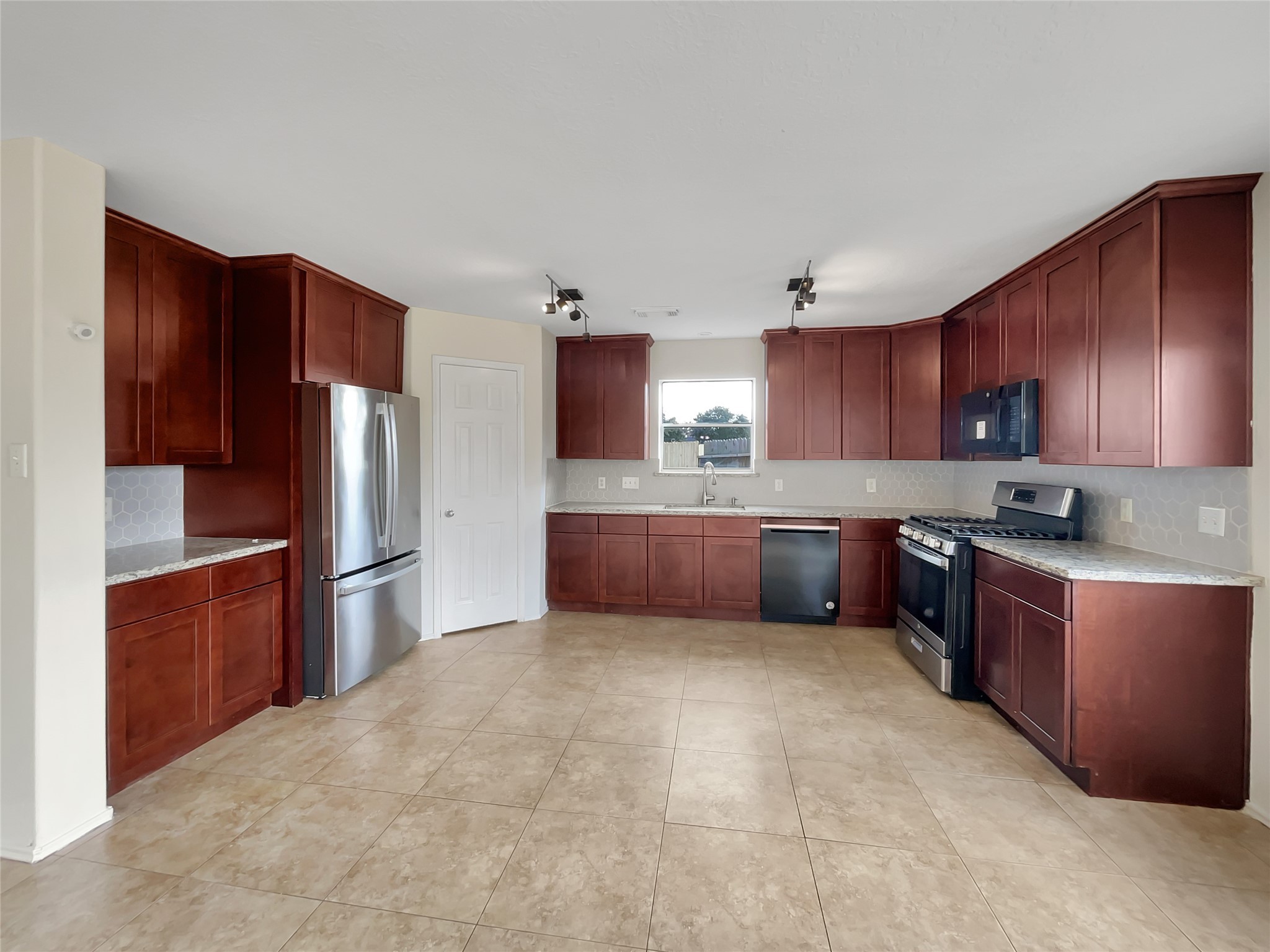 2618 Balsam Ridge Way Fresno, TX 77545 - Photo 11 of 20 a large kitchen with stainless steel appliances granite countertop a refrigerator and a stove top oven