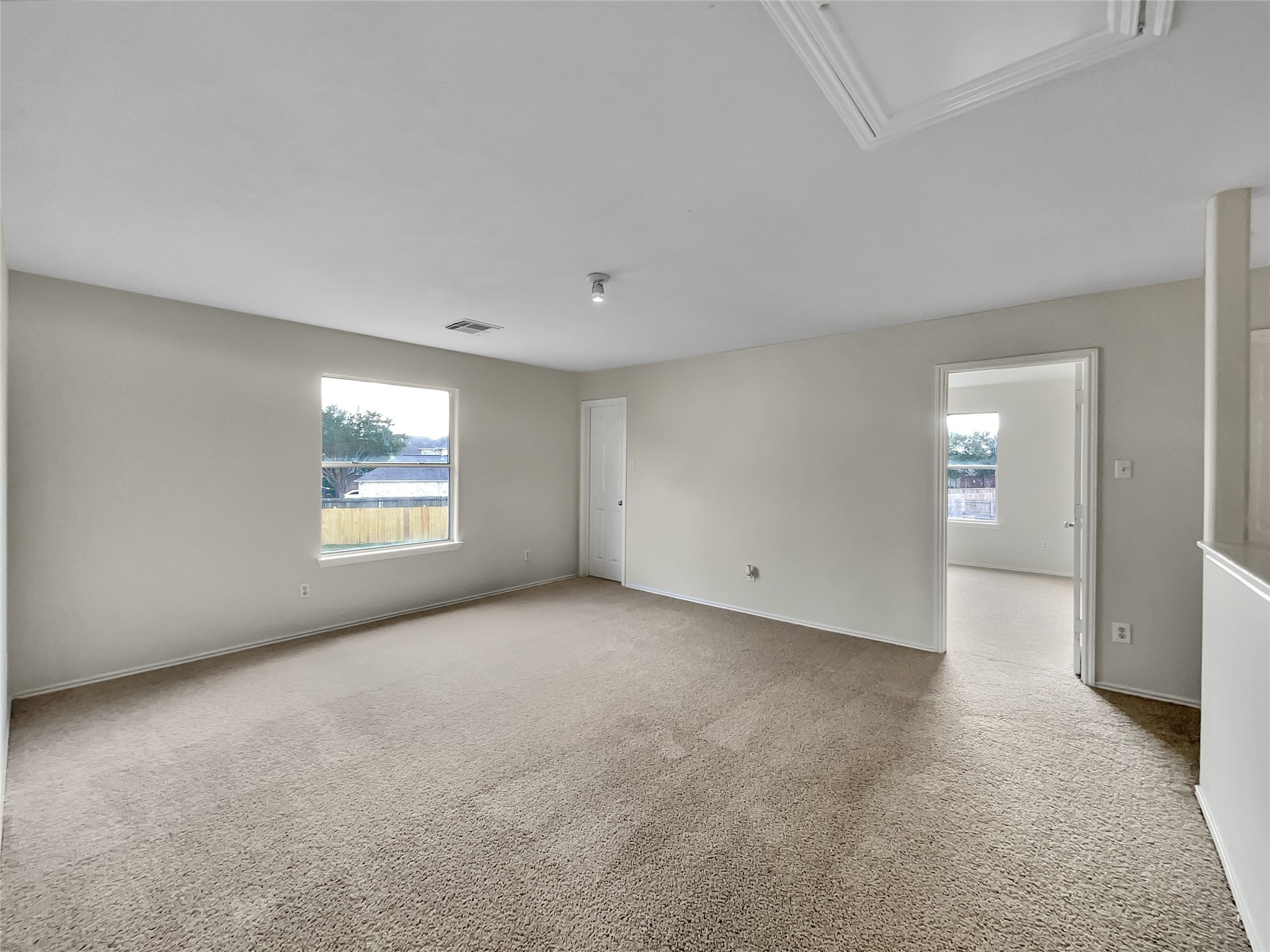 2618 Balsam Ridge Way Fresno, TX 77545 - Photo 13 of 20 an empty room with windows and entrance to other room