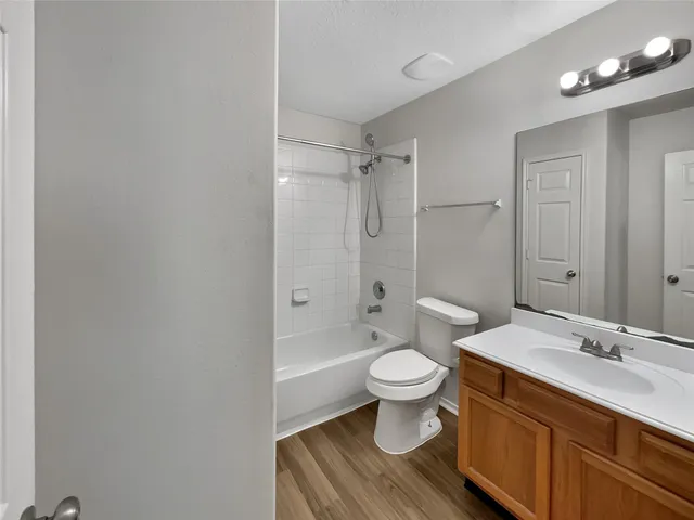 a bathroom with a sink toilet a mirror and shower