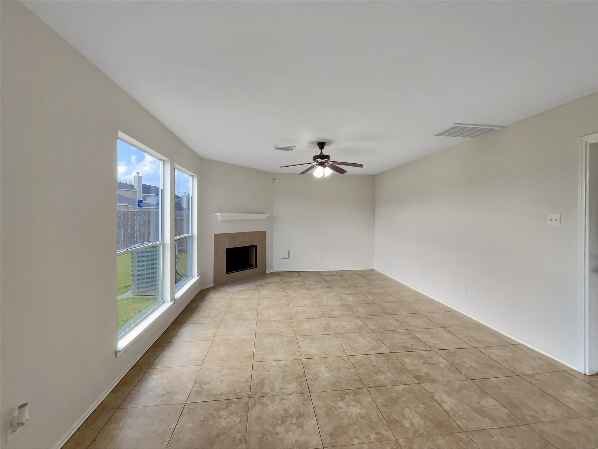 2618 Balsam Ridge Way Fresno, TX 77545 - Photo 10 of 20 en empty room with windows and fireplace