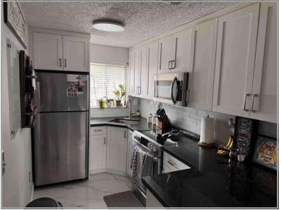8055 Northwest 8th Street, Unit 4 Miami, FL 33126 - Photo 3 of 11 a kitchen with a refrigerator stove and sink