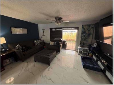 8055 Northwest 8th Street, Unit 4 Miami, FL 33126 - Photo 4 of 11 a living room with furniture and a flat screen tv