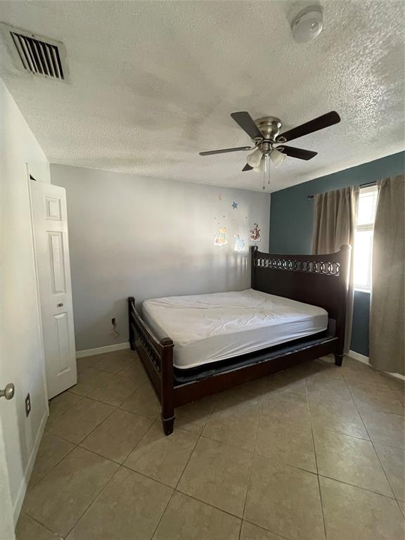 8055 Northwest 8th Street, Unit 4 Miami, FL 33126 - Photo 10 of 11 a bedroom with a bed and a chandelier