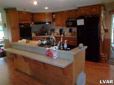 479 Bauer Road Bath, PA 18014 - Photo 4 of 9 a kitchen with stainless steel appliances granite countertop a refrigerator and a counter space