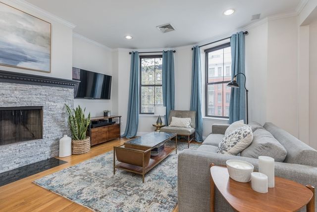 a living room with furniture and a fireplace
