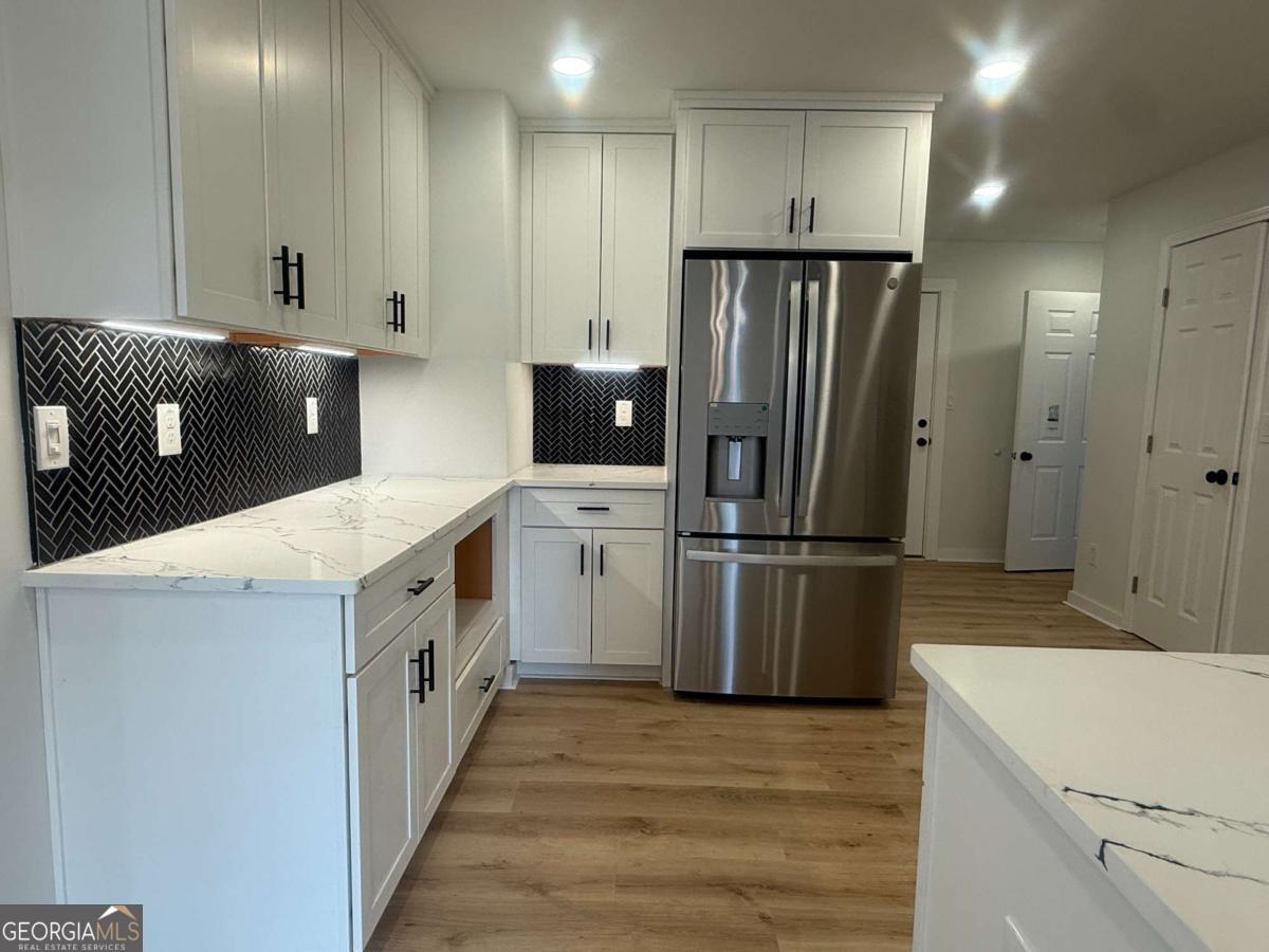 3112 North Avenue Decatur, GA 30033 - Photo 11 of 52 a kitchen with white cabinets and stainless steel appliances