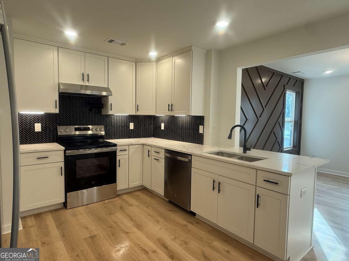 3112 North Avenue Decatur, GA 30033 - Photo 14 of 52 a kitchen with a sink cabinets and stainless steel appliances