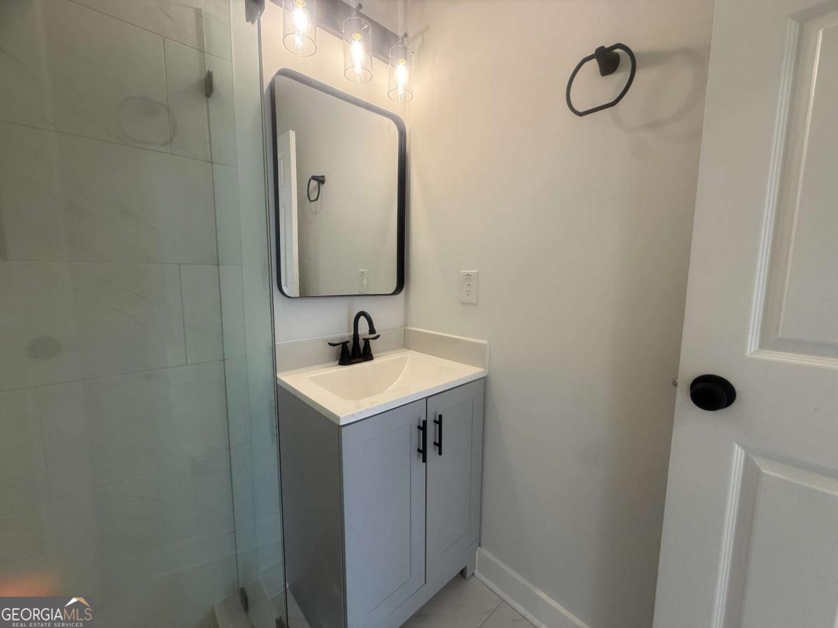 3112 North Avenue Decatur, GA 30033 - Photo 22 of 52 a bathroom with a sink and mirror with toilet