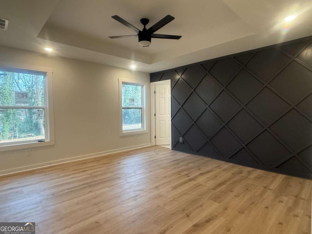 3112 North Avenue Decatur, GA 30033 - Photo 27 of 52 an empty room with wooden floor and windows