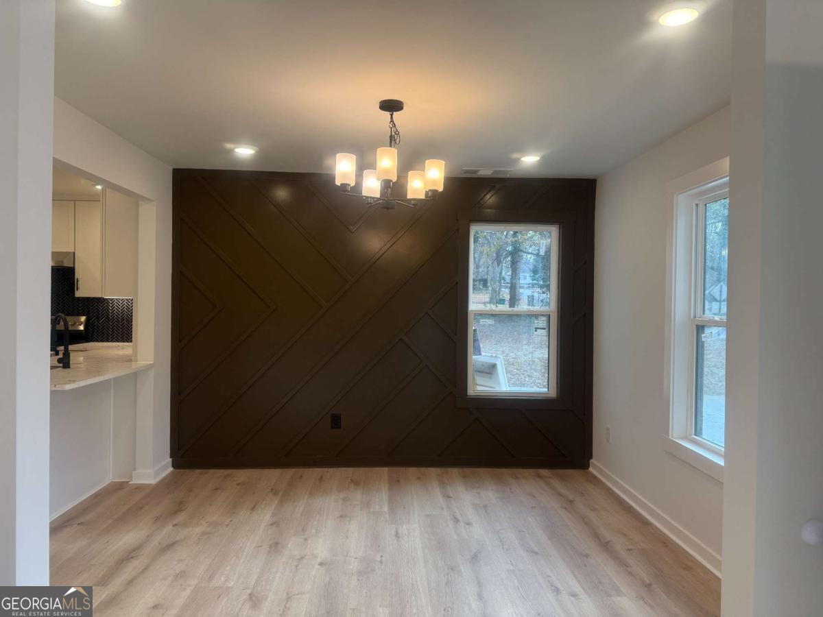 3112 North Avenue Decatur, GA 30033 - Photo 6 of 52 an empty room with wooden floor and windows