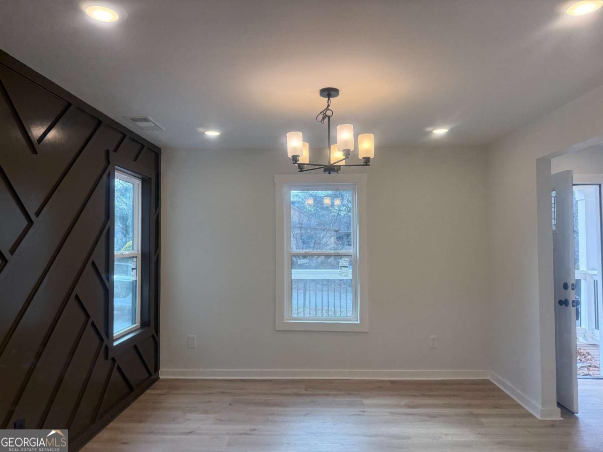 3112 North Avenue Decatur, GA 30033 - Photo 7 of 52 a view of empty room with window and hardwood floor