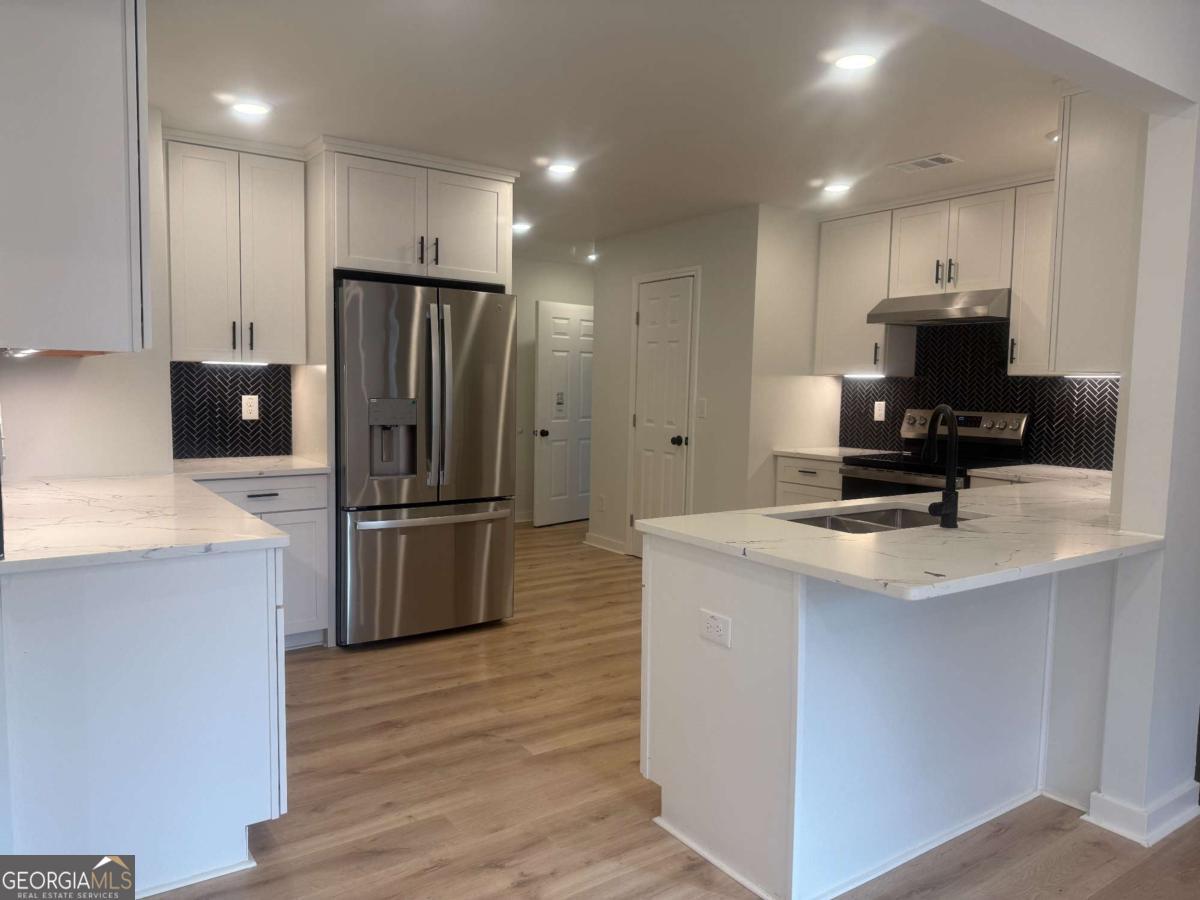 3112 North Avenue Decatur, GA 30033 - Photo 10 of 52 a kitchen with kitchen island a refrigerator sink and microwave