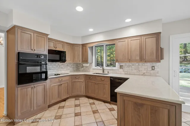 a kitchen that has a sink and a stove in it