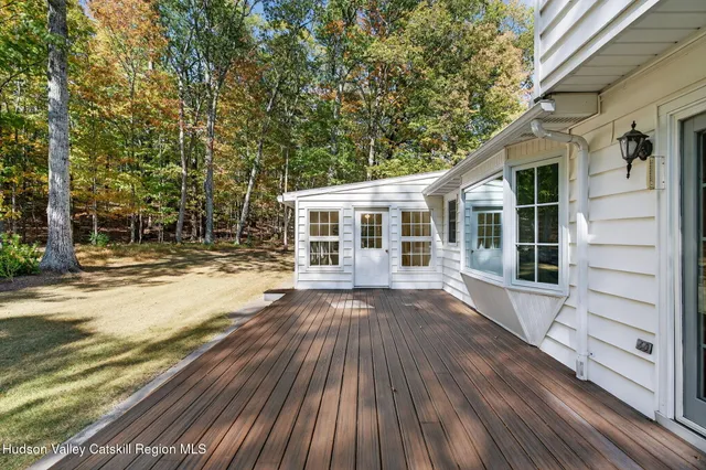 a view of house with backyard and glass door