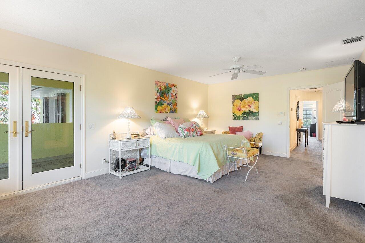 243 Florenada Terrace Boca Raton, FL 33486 - Photo 24 of 48 a bedroom with a bed and a chandelier