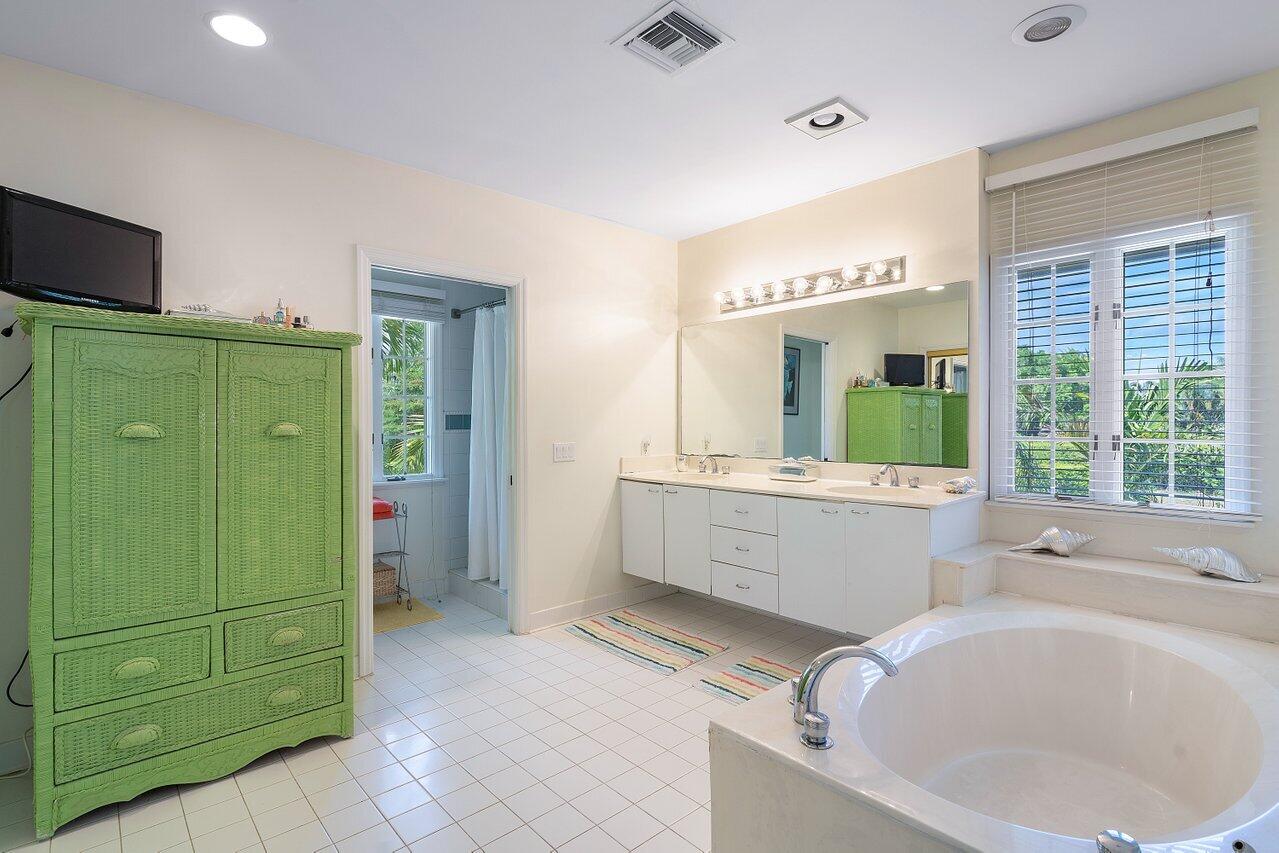 243 Florenada Terrace Boca Raton, FL 33486 - Photo 26 of 48 a large bathroom with a tub a sink and a large window