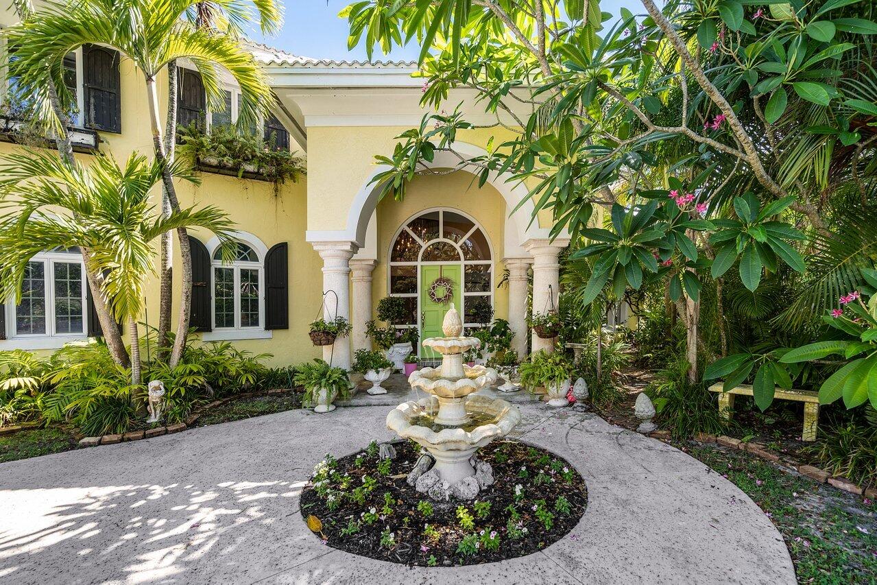 243 Florenada Terrace Boca Raton, FL 33486 - Photo 3 of 48 a view of a house with a yard garage and sitting area