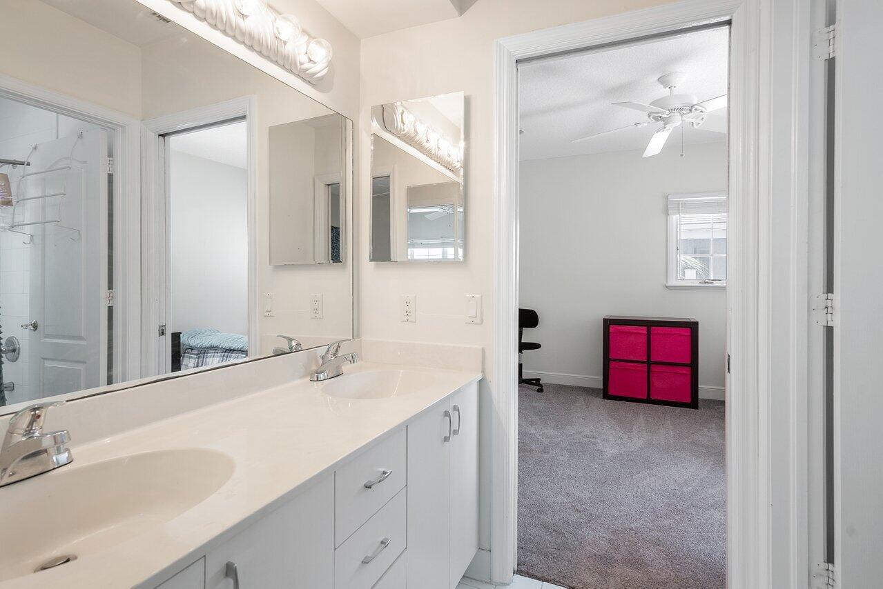 243 Florenada Terrace Boca Raton, FL 33486 - Photo 32 of 48 a bathroom with a double vanity sink and a mirror