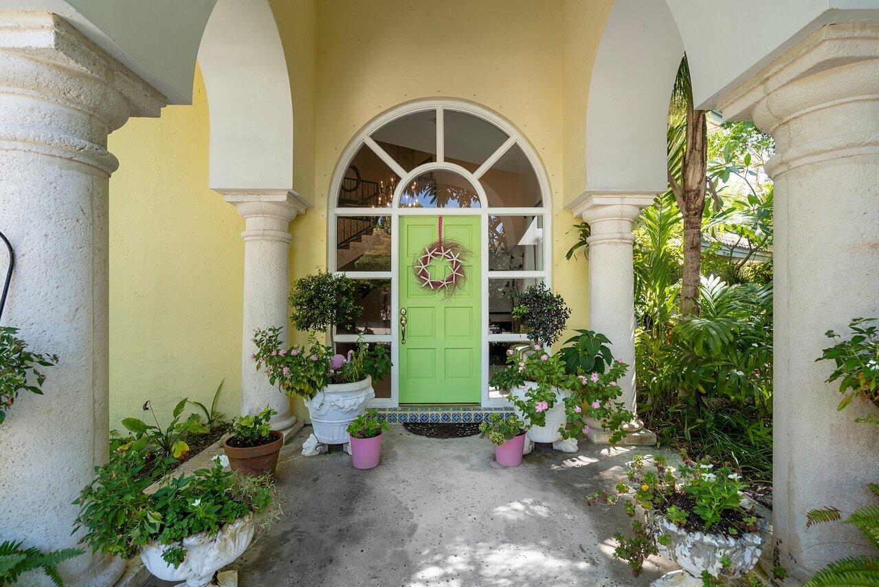 243 Florenada Terrace Boca Raton, FL 33486 - Photo 4 of 48 a view of a brick house with potted plants