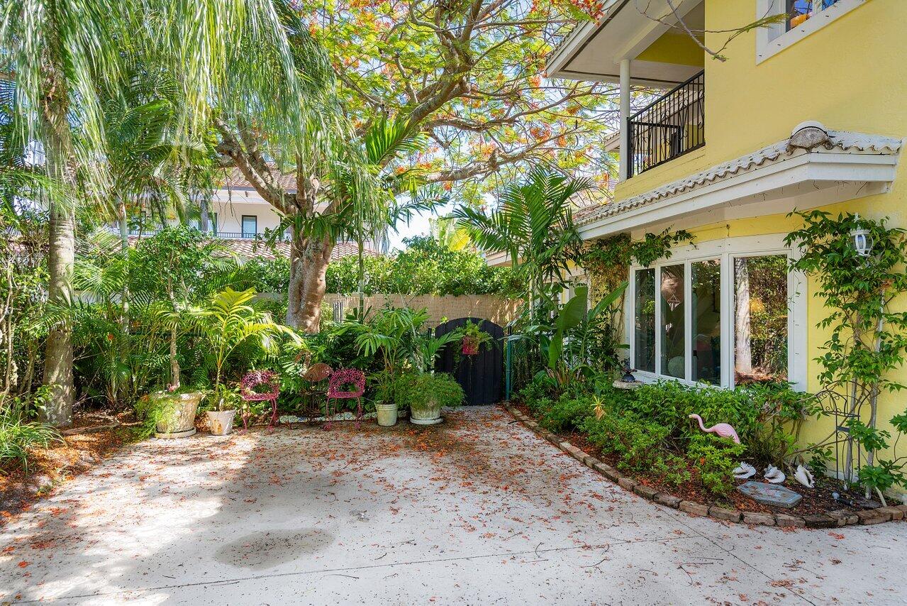 243 Florenada Terrace Boca Raton, FL 33486 - Photo 42 of 48 front view of a house with a garden